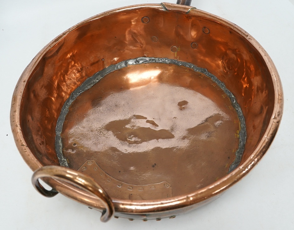 Two copper pans, one handled and the other with cover, 38cm diameter. Condition - fair